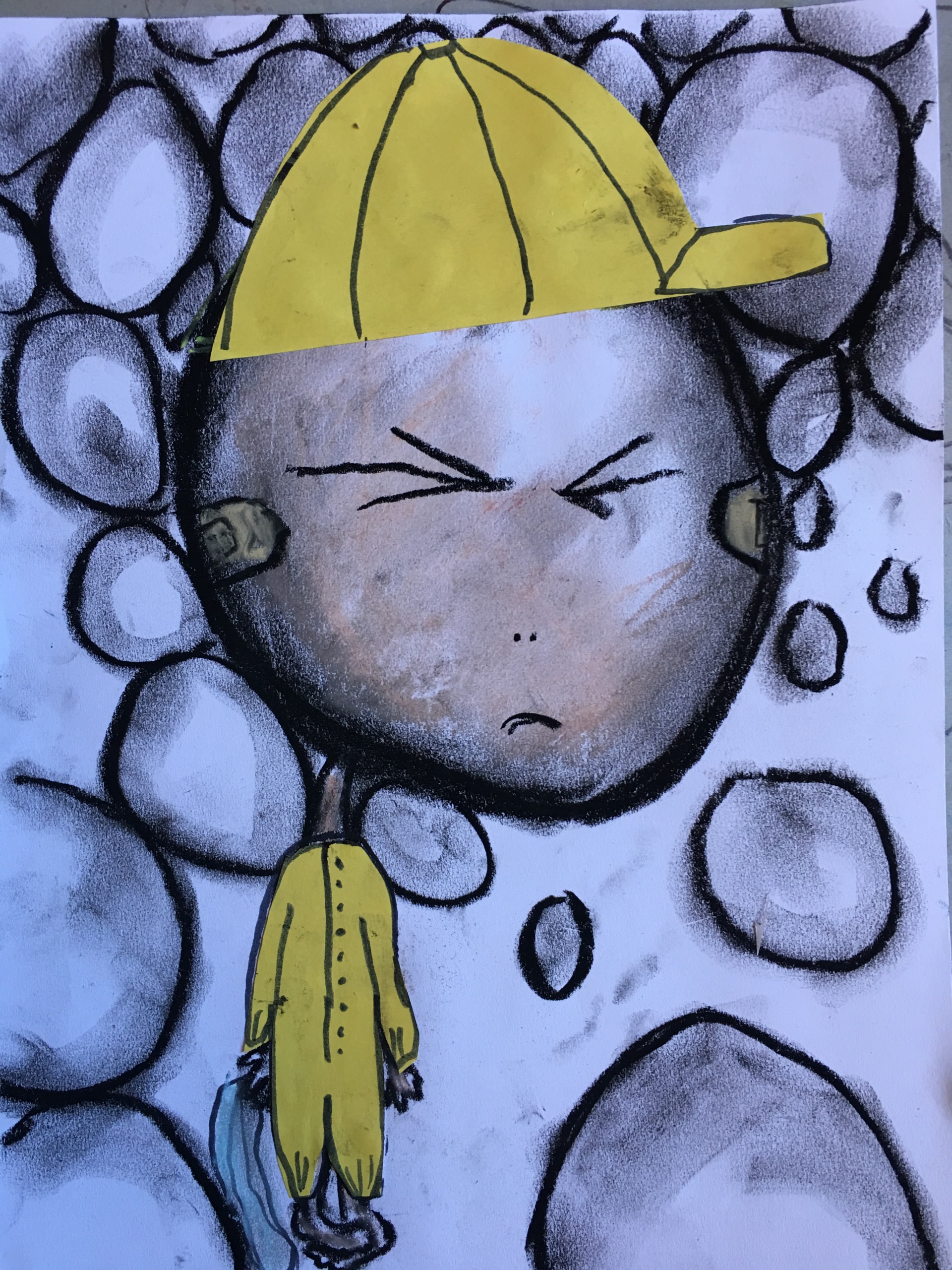 Child's drawing of a frowning person in a yellow cap and outfit, with a background of shaded circles.